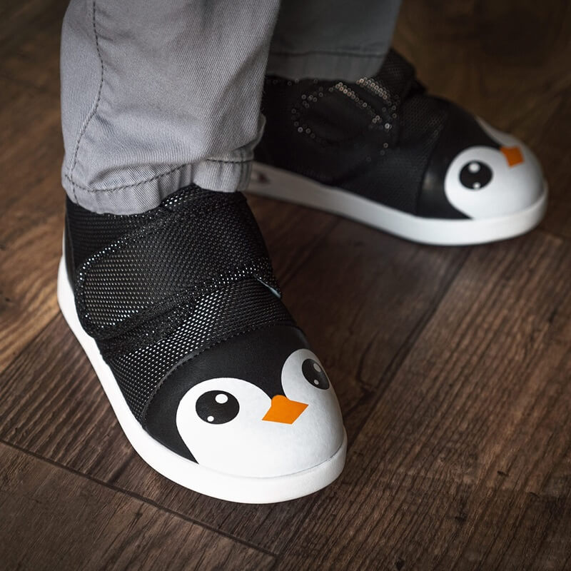 Child wearing Black Penguin shoes