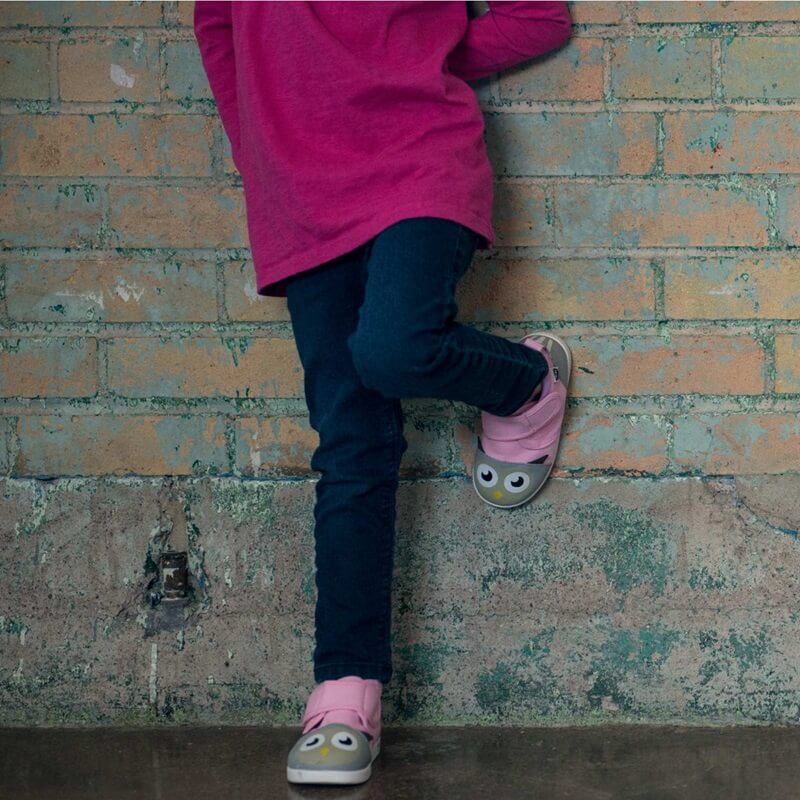 Girl leaning against wall wearing Pink Owl shoes