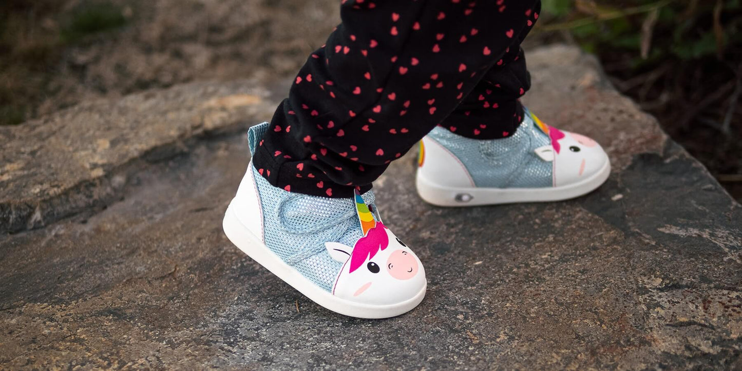 Child walking in Unicorn shoes.