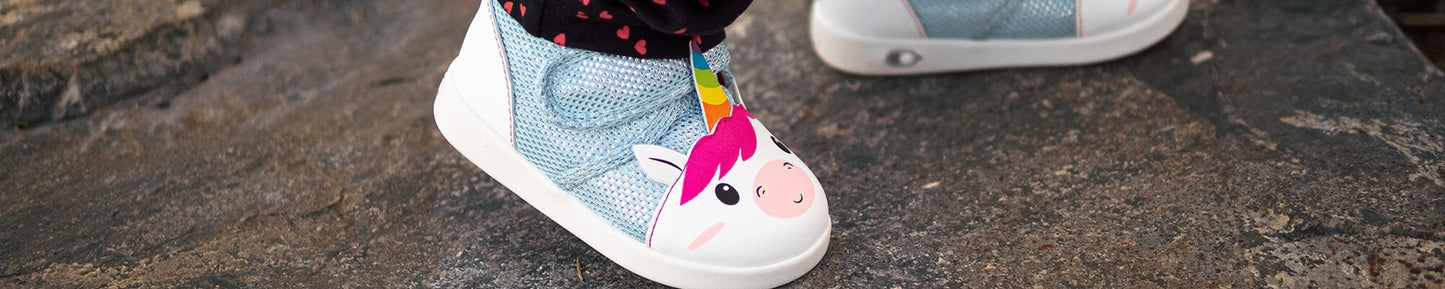 Child walking in Unicorn shoes.