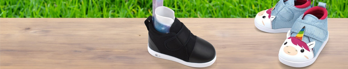 Black shoe and Unicorn shoe on table.